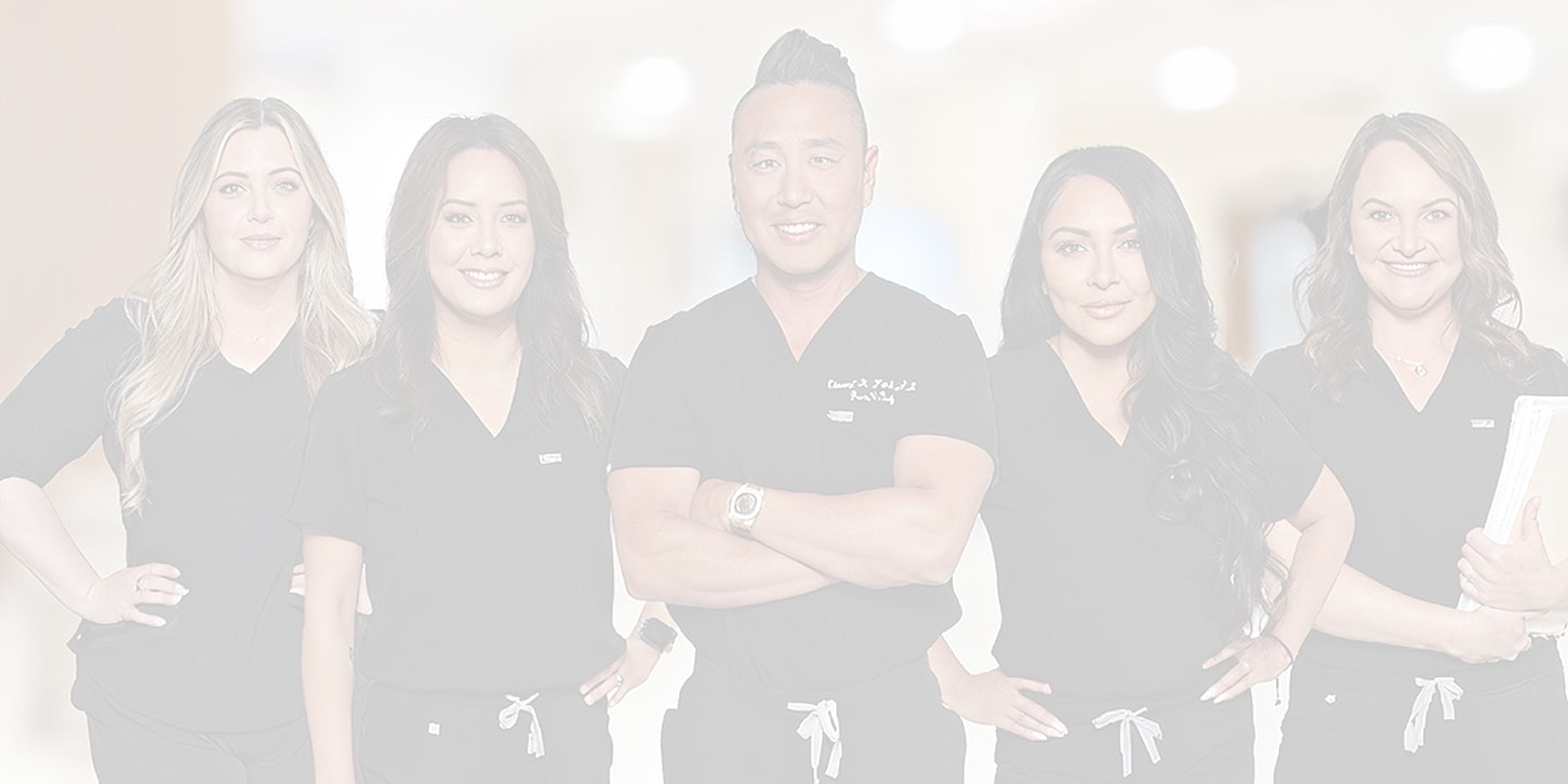 Healthcare team in professional attire smiling together.