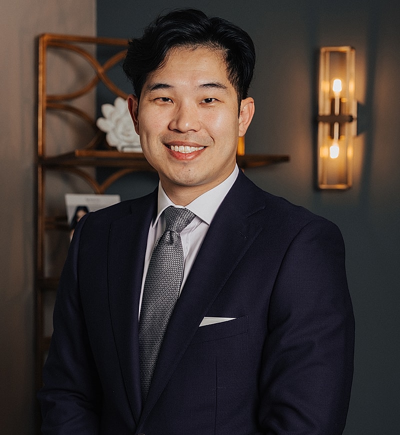 Professional man in suit, smiling confidently.