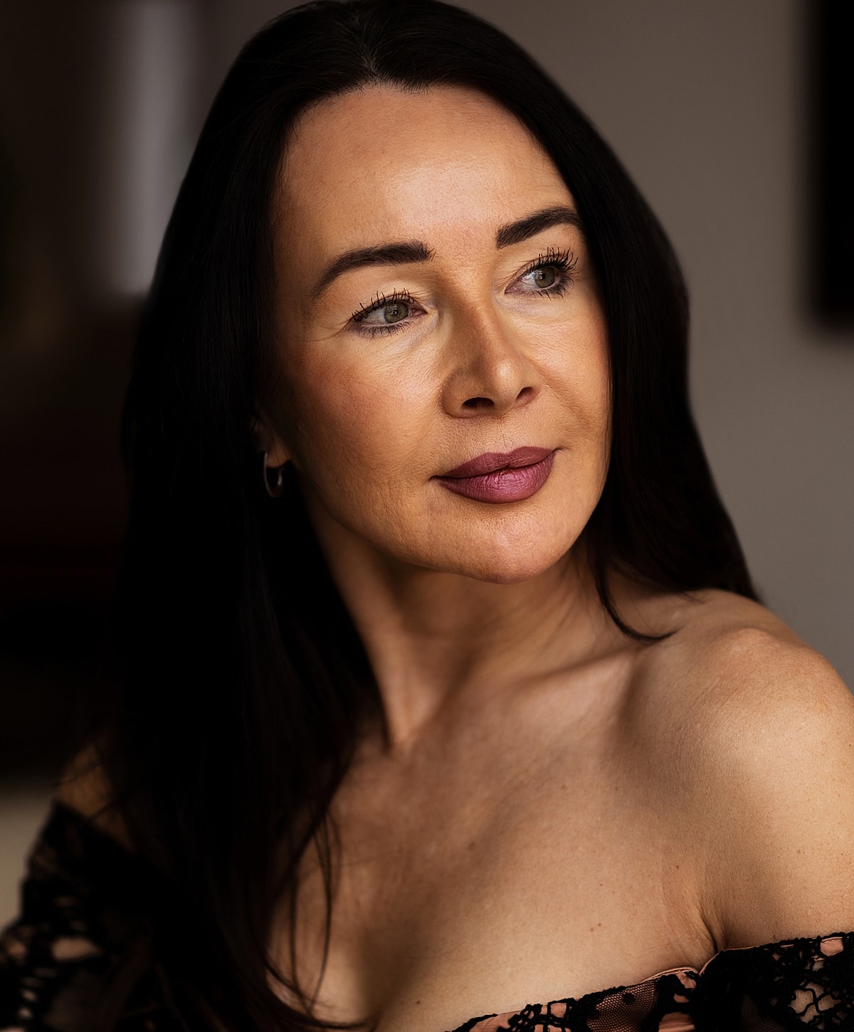 Woman with long dark hair and soft expression.