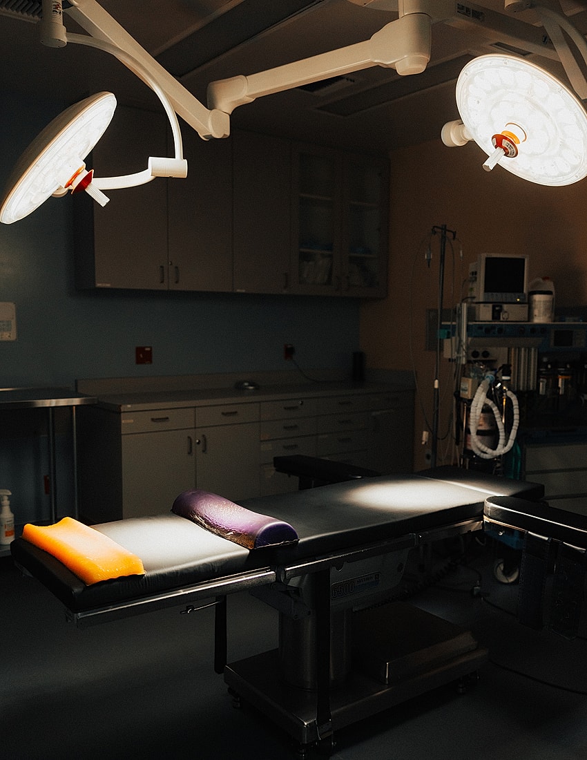 Surgical room with operating table and lights.