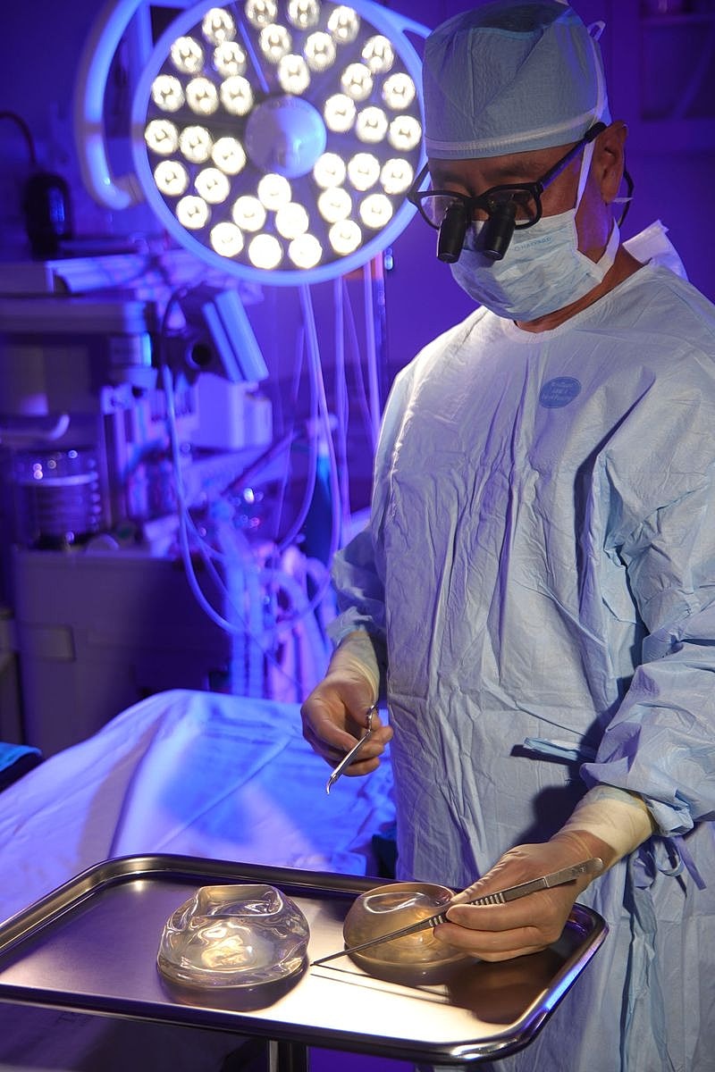 Surgeon preparing for a procedure in operating room.