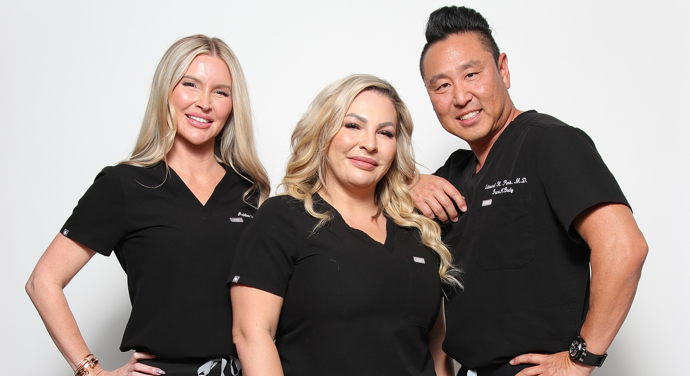 Medical professionals posing together in scrubs.
