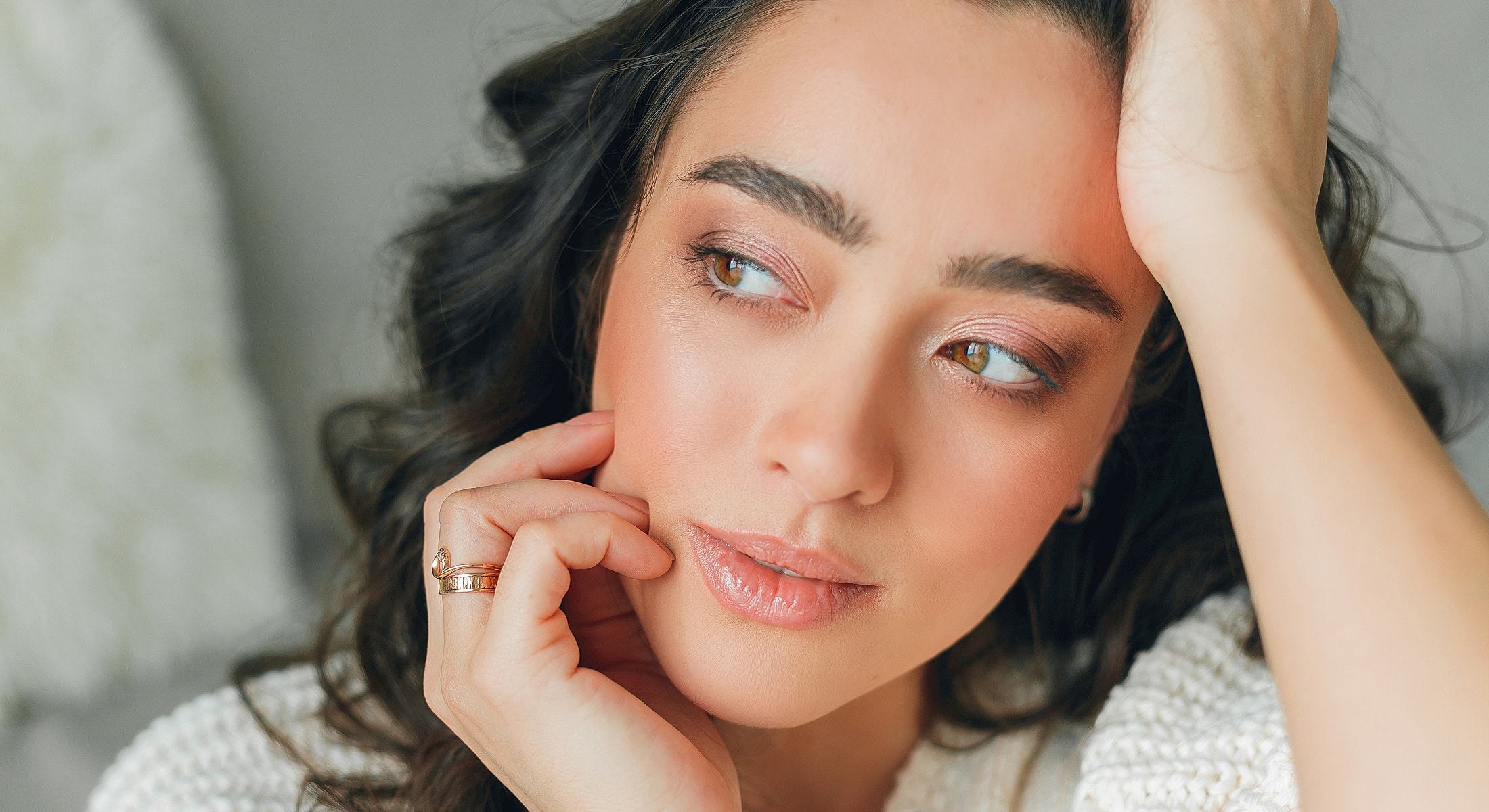 Close-up of a woman with thoughtful expression.