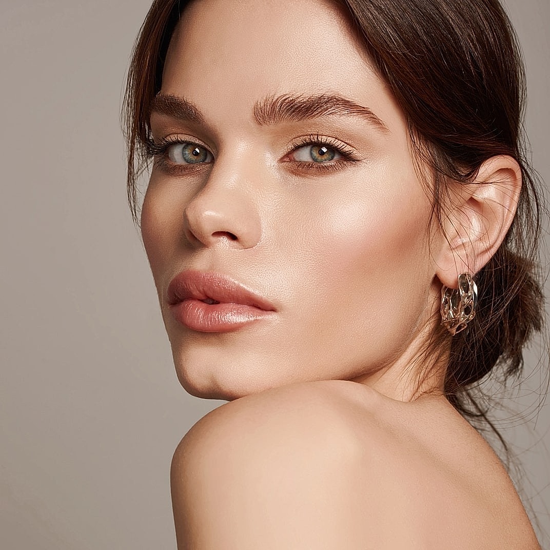 Close-up of a woman's face and shoulder.