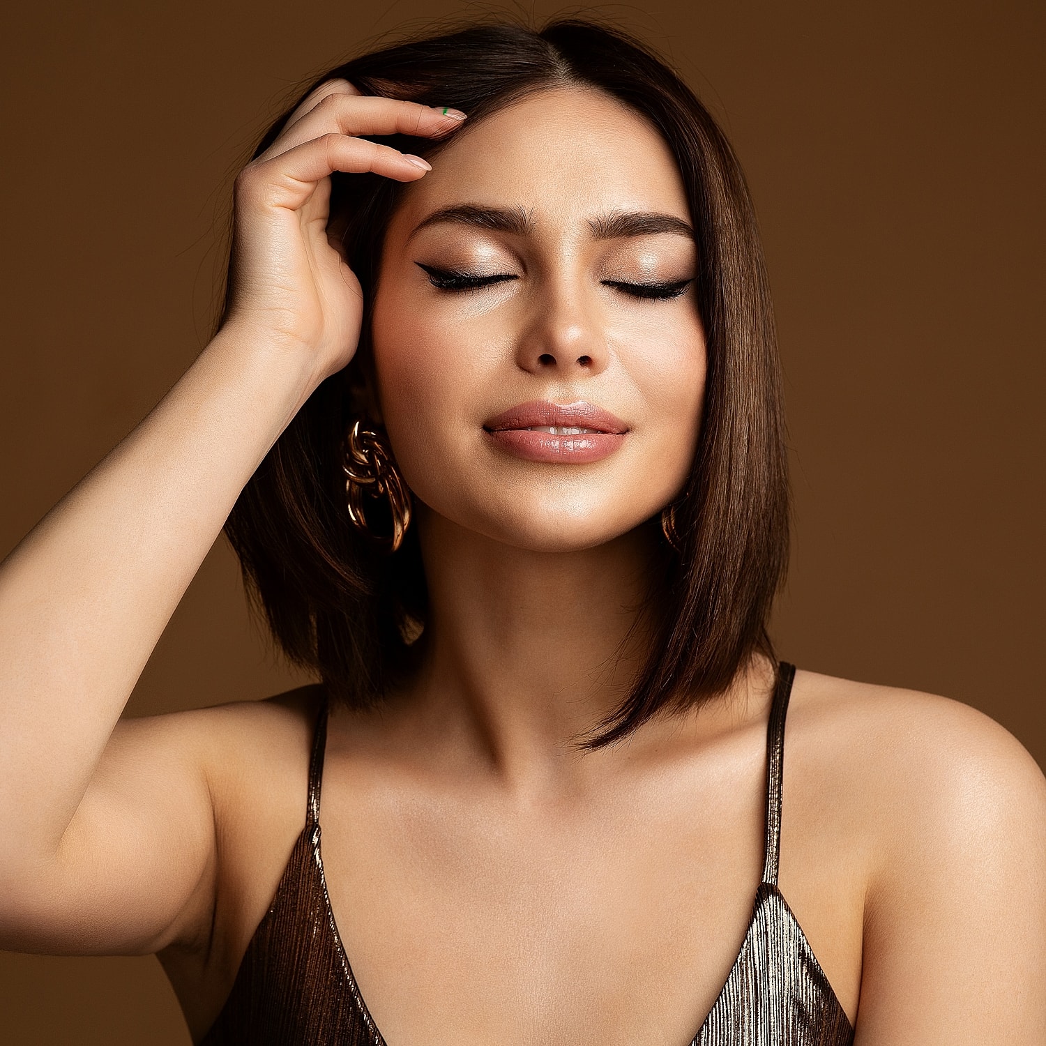 Woman with closed eyes and stylish hairstyle.